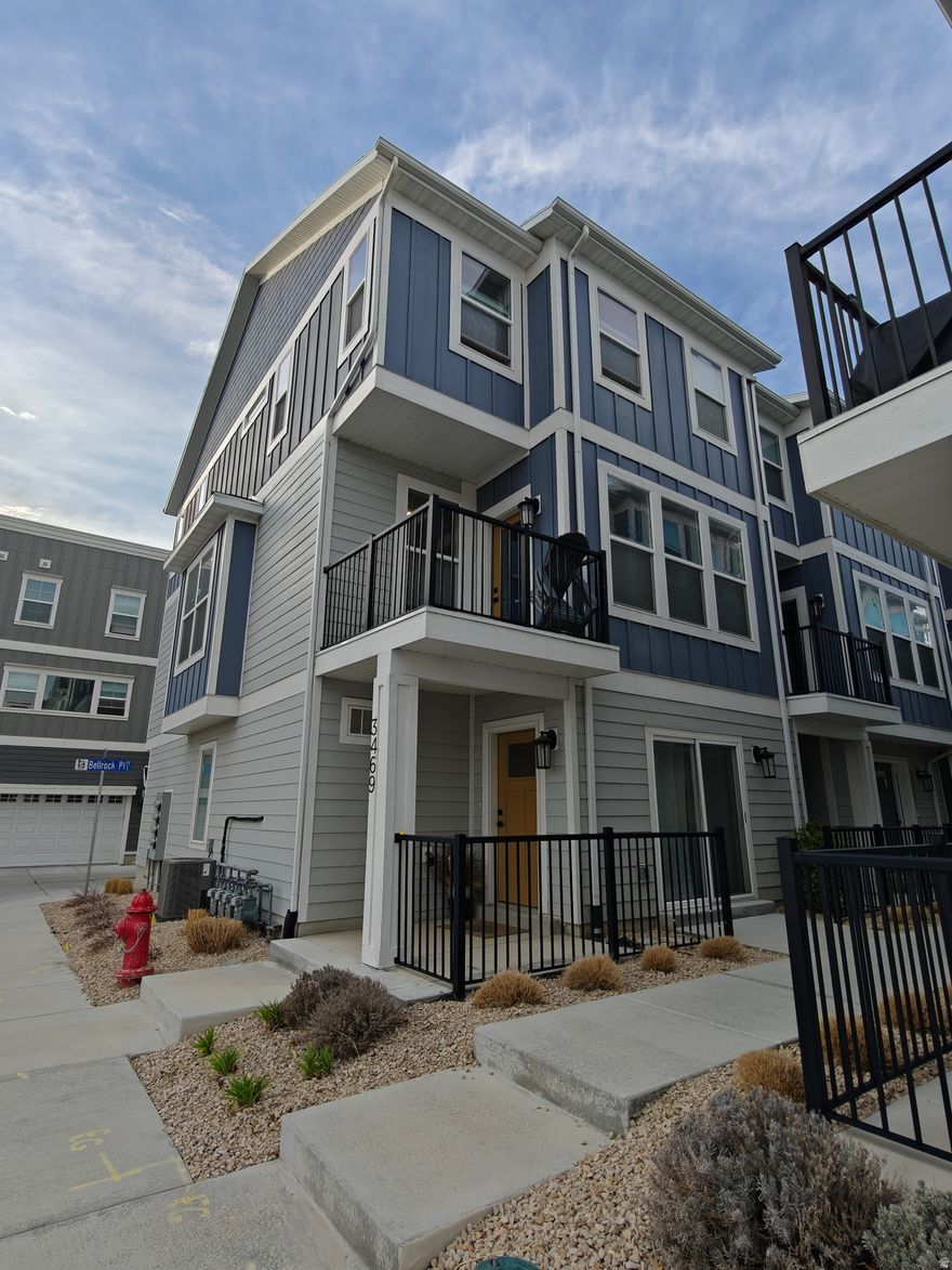 This turn-key end unit has an unobstructed south facing view, enjoying abundant amounts of natural light. Conveniently located near shopping, dining, and just minutes from the airport, downtown, freeway entrances, and Trax. The "Denton" floorplan features a two-car garage, an open and spacious main level, and an oversized kitchen with a large island for ample seating. Construction finished on this home December 2022 and came with lots of upgrades not included in the base models: Upgraded soft close cabinets Contemporary electric fireplace with floor to ceiling shiplap Stair accent lighting (photocell activated, no switch) Quartz countertops Rollout garbage located in the island (kitchen) Soft close toilet seats Tiled laundry room Tiled owner shower Tiled bathroom floors (upgraded from laminate) Black accent package (bathroom finishes, cabinet handles, door handles, etc.) Premium carpet with 8lb 1/2" memory foam Water softener rough-in Gas line rough-in (main floor deck) Wi-fi linked garage door opener Additionally, the owner has added the following upgrades to the garage: Professionally done epoxy flake floor coating Finished walls (professionally done) Ceiling mounted storage shelves Outdoor spaces include a main floor balcony/deck ground floor patio. Interior highlights include 9' ceilings on the main level, quartz countertops, a euro-style shower door, designer tile flooring, and soft-close cabinets. As one of the first units built, this home boasts premium finishes throughout.