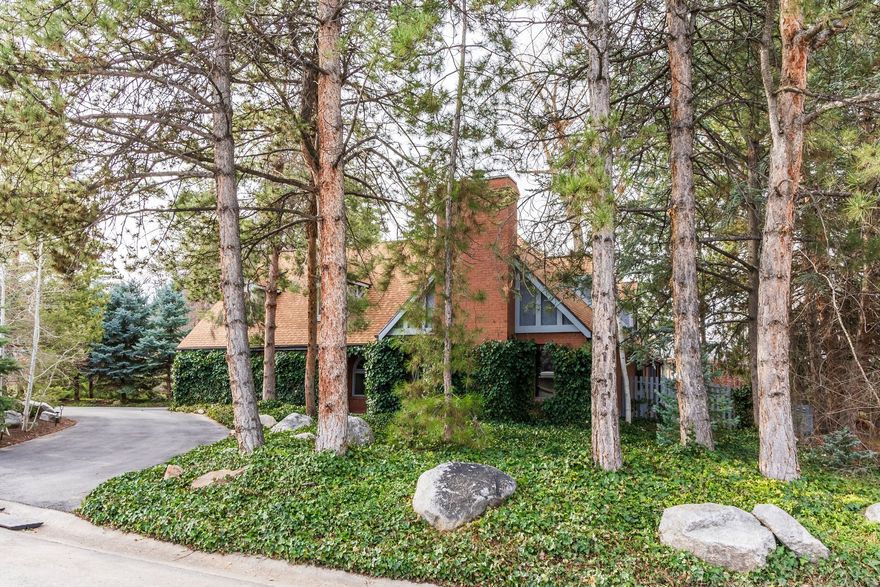 This brick two-story is ideally positioned nearby the prestigious Cottonwood Club which offers golf, tennis, swimming, and elegant gathering spaces just moments from your doorstep. Set on a beautifully landscaped lot that embraces its wooded ambiance this home's ivy-covered brick exterior creates classic charm with a convenient pull-through driveway and two-car garage with additional storage. Inside, the main level is designed with an open flow beginning in the formal living room and extending through the home's updated kitchen and guest bathroom with high tank pull chain toilet, creating a comfortable setting for both everyday living and entertaining. The upper level features two bedrooms in addition to the primary suite. Recently cleaned carpets enhance the home's move-in ready appeal. The yards are landscaped to preserve the tranquil and wooded character of the property while minimizing yard maintenance. Located just minutes from the I-215 belt route and the exciting Cottonwood Mall redevelopment, including Trader Joe's, Megaplex Theatres, dining, and boutique shopping, this residence offers a rare combination of peaceful neighborhood living with exceptional convenience.