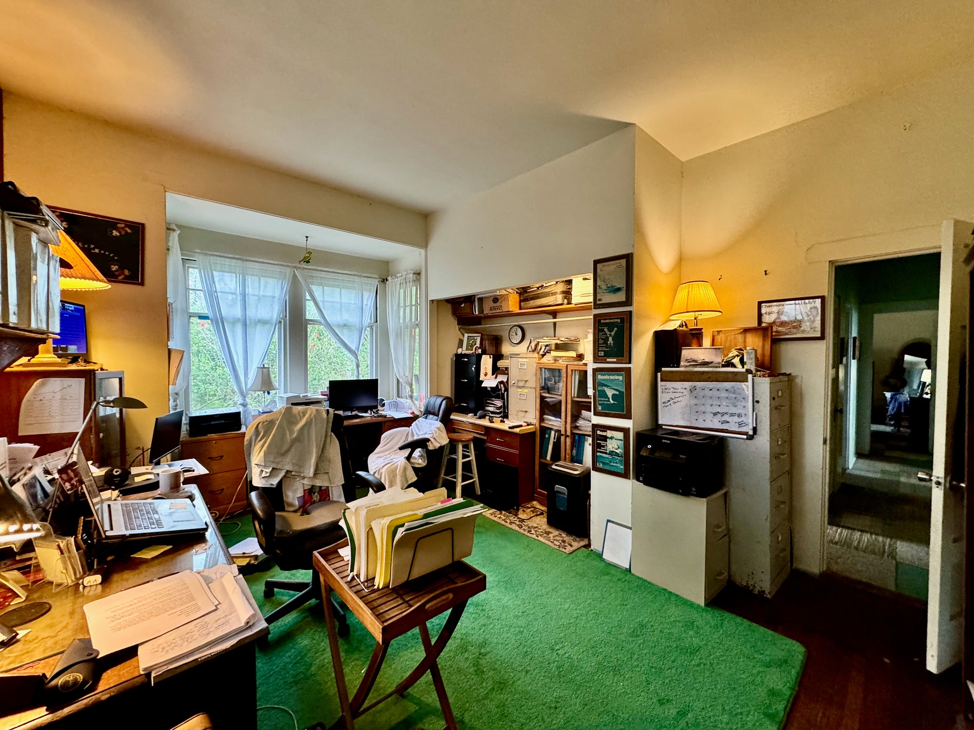 Bedroom one used as an office with access to secondary hallway leading to bathroom and primary bedroom