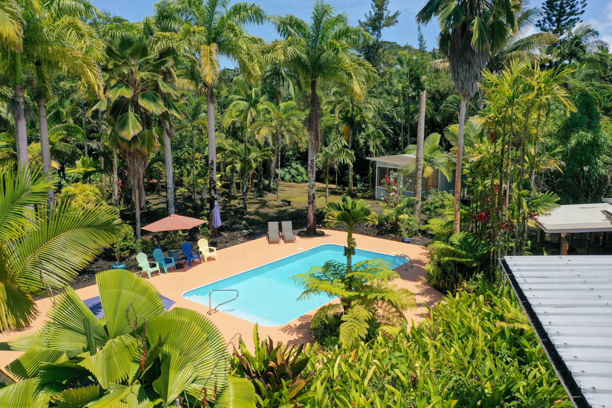 A magical property presented on 1.85 lush tropical acres boasts THREE dwellings - the 3 bed/3 ba main home (ea bed has it's own ba), a 1 bed/1 ba Ohana w/separate driveway, totally private from the main home via fence & a fully contained studio tiny home