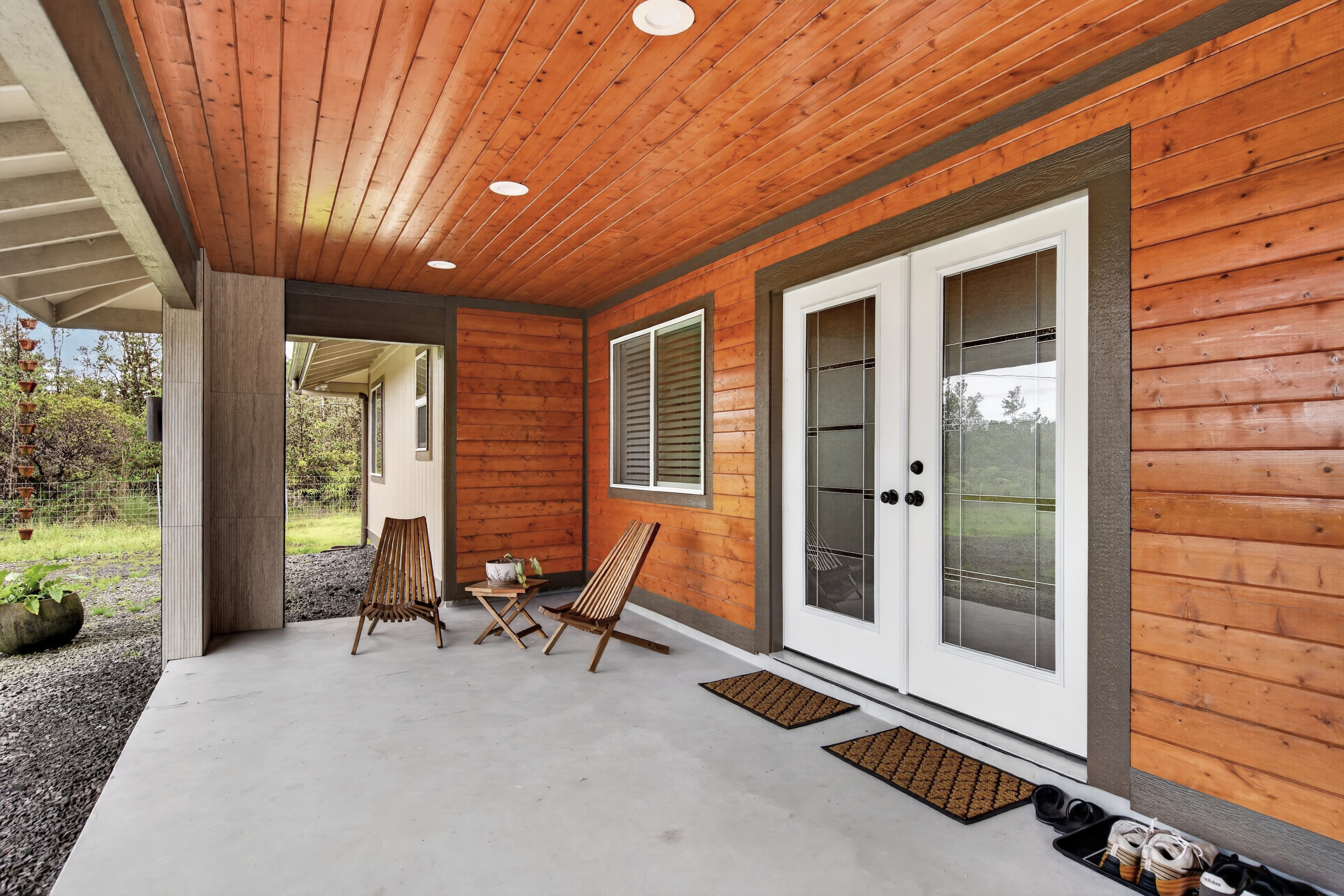 Spacious front lanai with beautiful wood accent walls.
