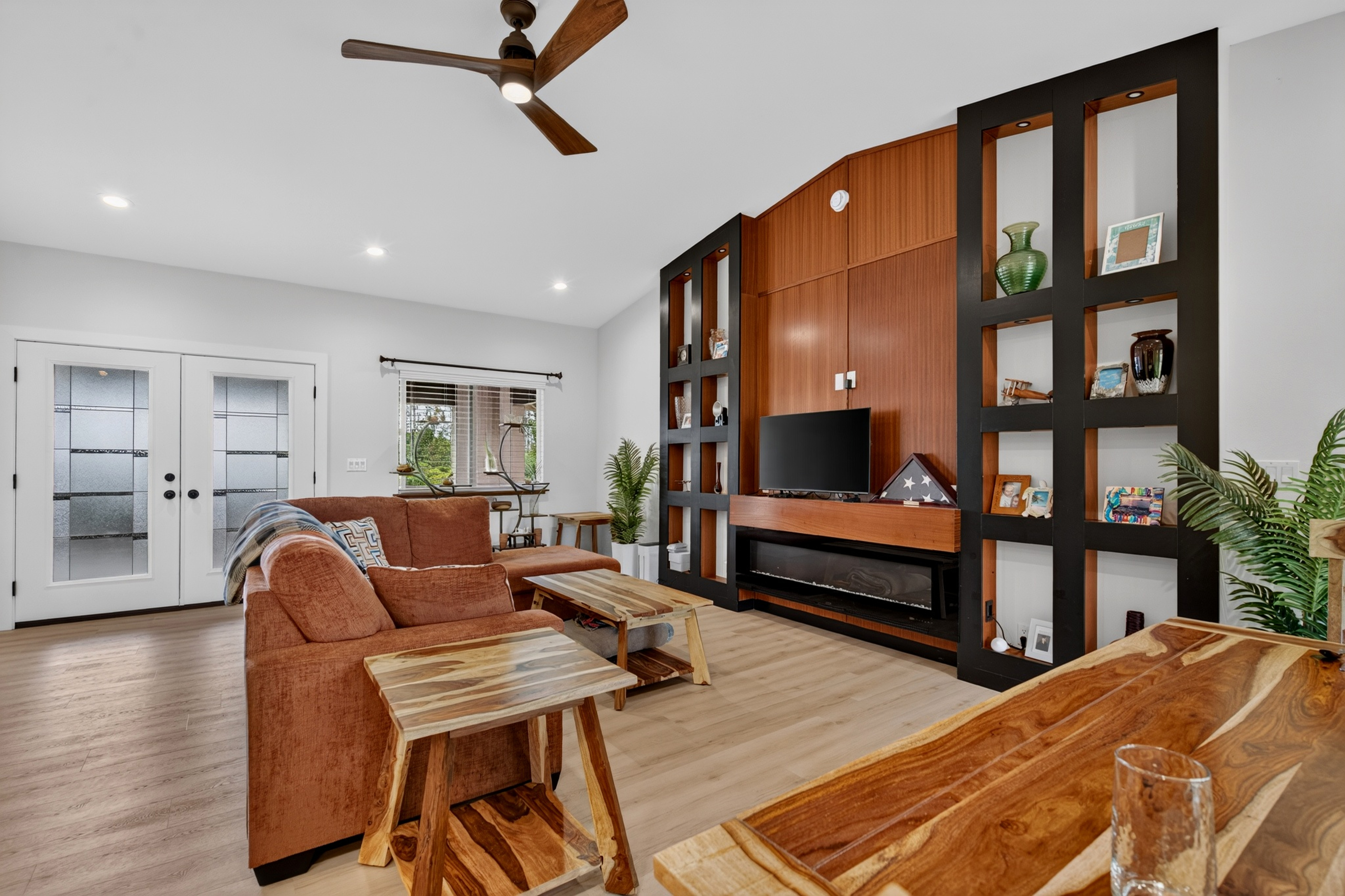 Large main living area with built in shelves and electric fire place.