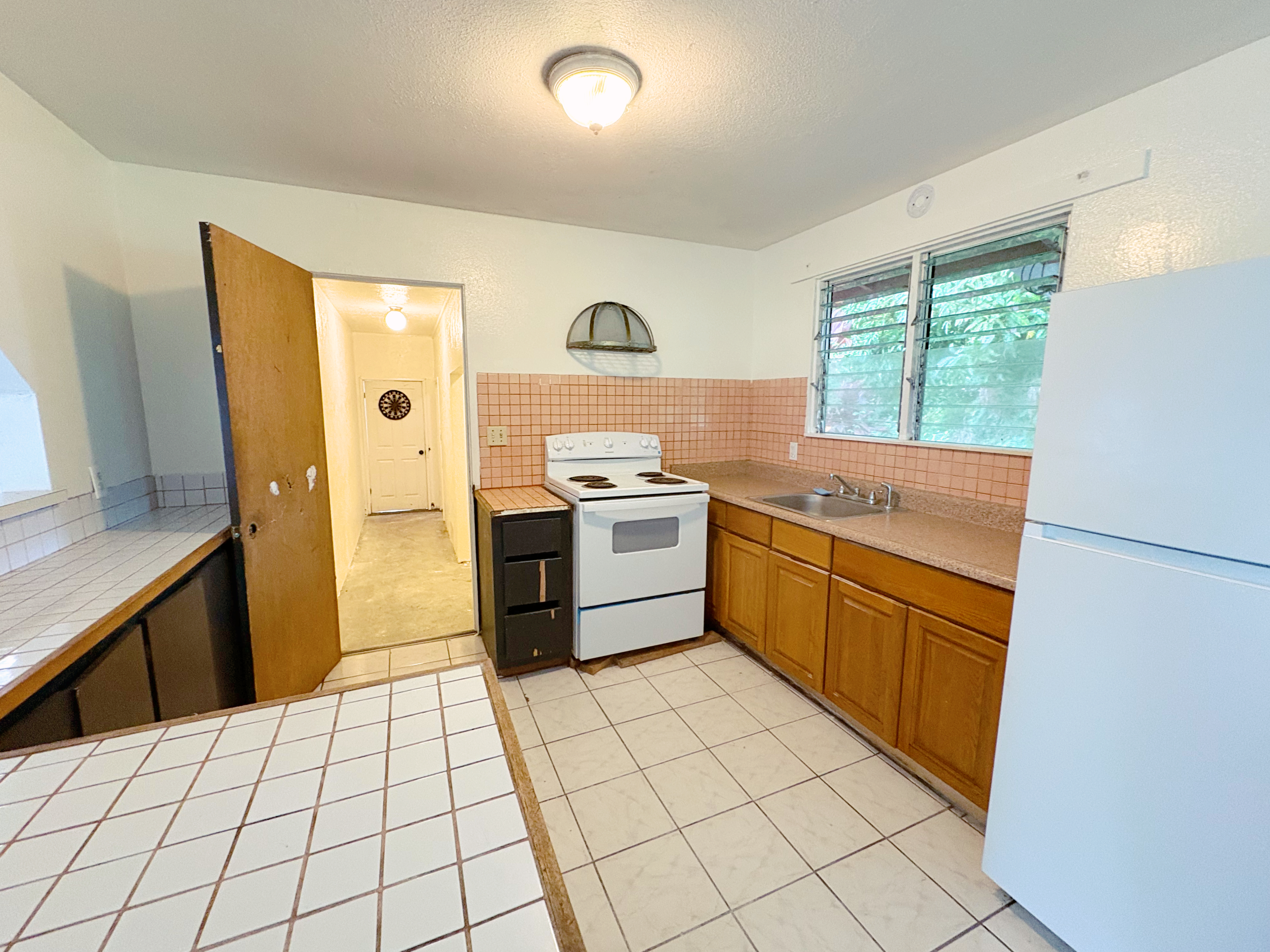 Looking into the kitchen. Appliances included as-is.