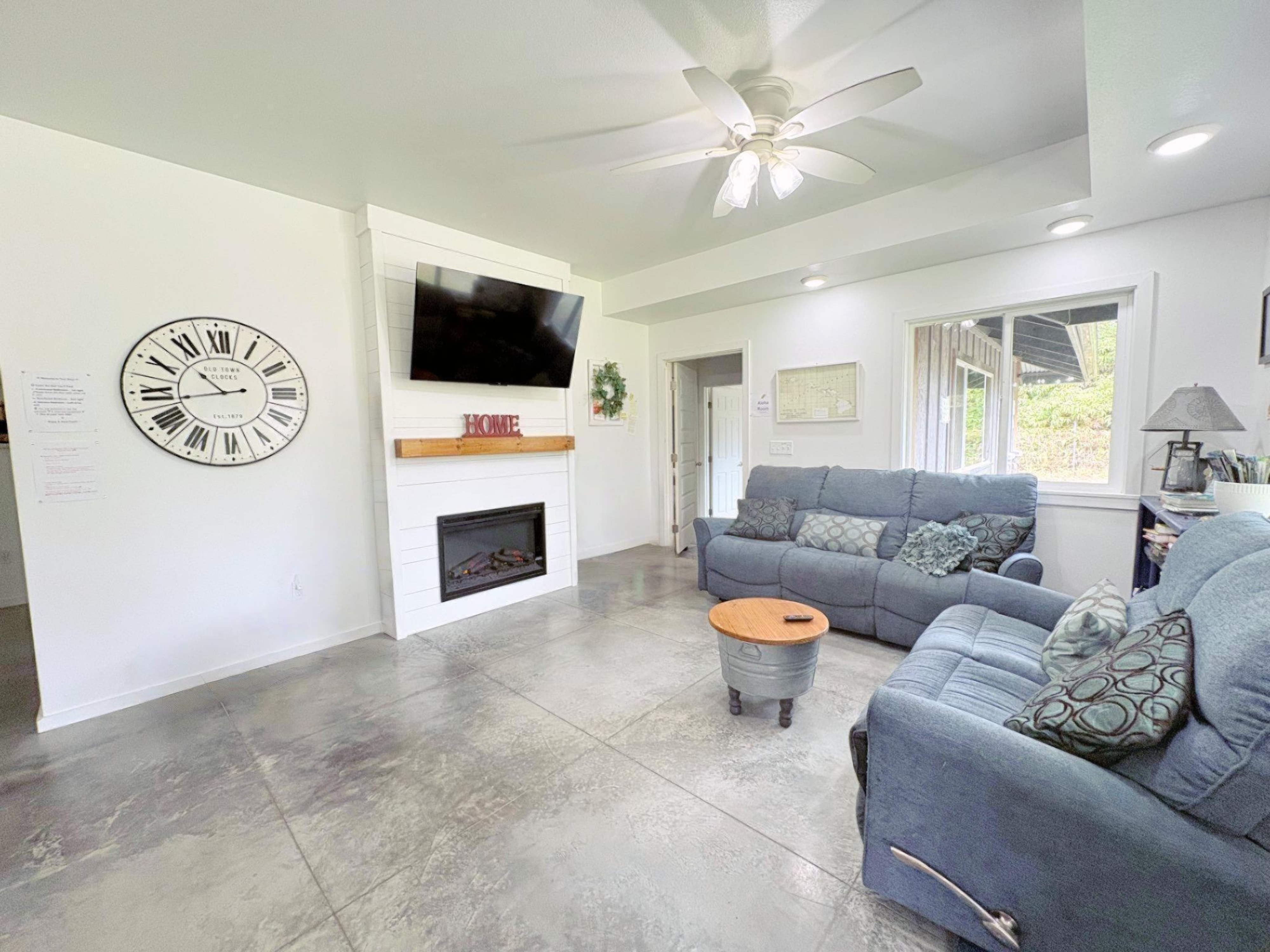 Spacious living room with cozy fireplace.