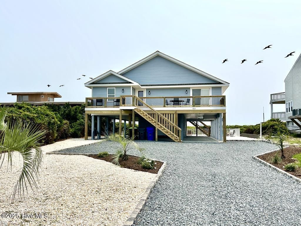 Photo of 323 Caswell Beach Road, Oak Island, NC 28465 (MLS # 100533817)
