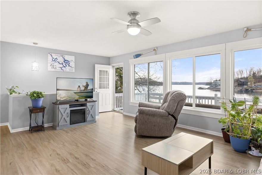 Discover the ultimate lakefront retreat with this stunningly remodeled 4-bedroom, 2-bathroom ranch, perfectly positioned at MM 5.5 in Lick Branch Cove. This residence offers a rare combination of BIG views and incredible DEEP water (25–30 ft), providing an exceptional environment for boating and swimming alike. Every inch of this home has been polished to perfection. The interior boasts a comprehensive remodel featuring updated flooring, contemporary lighting, and high-end windows that flood the space with natural light. The gourmet-inspired kitchen and baths shine with new cabinets and sleek countertops, offering a "fresh and clean" aesthetic throughout. Step outside to your private aquatic playground: a 2-well dock (10x28 & 8x8 PWC) equipped with a boat hoist, PWC hoist, swim platform, and wet steps for easy water access. Situated in a peaceful neighborhood on a well-maintained road, the property provides ample parking and effortless access to the shoreline. Whether you are looking for a tranquil full-time residence or a high-energy vacation getaway, this lakefront treasure is move-in ready. Bring your tape measure and see the depth for yourself—this is the one!