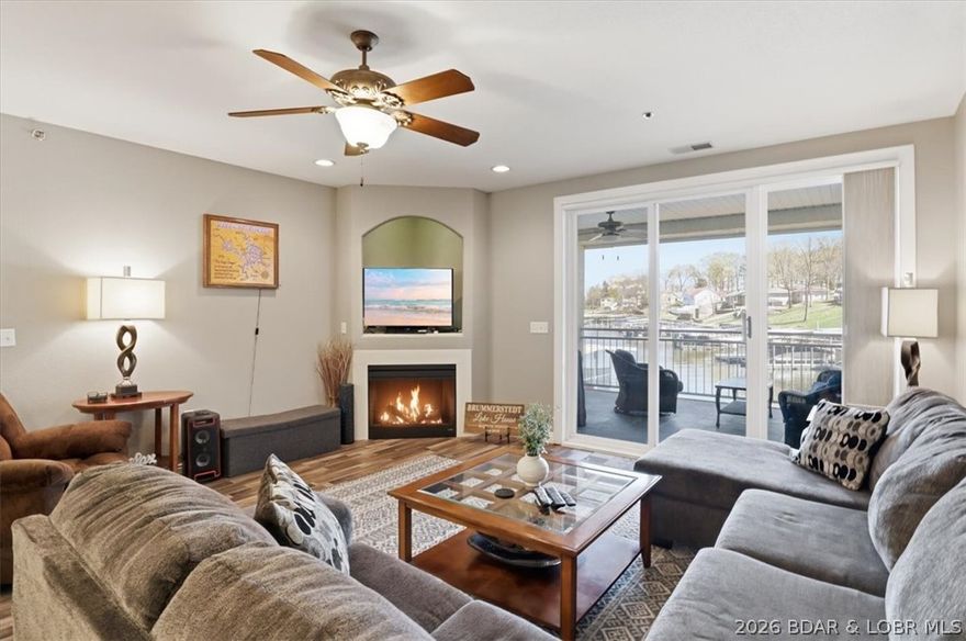 Luxury Lakefront Living at Majestic Pointe! Located at the 12MM in an exclusive gated community of only 24 units, this beautifully updated 3BR/3BA condo offers the perfect blend of comfort, style, and convenience. This desirable lower-level unit features elevator access from driveway to dock, providing easy, no-step living. The open-concept layout is designed for entertaining, with granite countertops, tiled backsplash, updated appliances, and a bright, spacious living area. Step outside to the screened-in, tiled deck and enjoy peaceful lake views the ideal setting for morning coffee or sunset relaxation. The spacious primary suite includes a jetted tub, walk-in shower, and updated finishes. Enjoy beautifully maintained grounds, a lakefront pool, and easy access to your 12x32 boat slip. Whether you’re seeking a full-time residence or a weekend retreat, this exceptional condo delivers the ultimate Lake lifestyle.