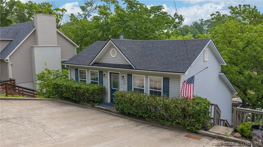Move-in ready & perfectly positioned in sought-after locations by land & water! This 3 bed / 3 bath home sits just off Bagnell Dam Blvd and the Osage 17MM, in a protected cove—right by The Reserve, Backwater Jacks & Dog Days. Featuring 1,630 sqft, the home has been recently updated throughout with fresh paint, LVP flooring & modern touches, making it truly turnkey. Functional layout features two bedrooms with private baths on the main level, while the lower level offers an open living/kitchen area with wood-burning fireplace, plus a spacious primary suite with walk-in closet, dual vanities, walk-in tile shower and deck access. Also has a flat driveway which adds to the convenience. Enjoy lake life with easy access by water and a prime central location by land. Whether full-time, weekend escape or investment, this is your chance to own the lake lifestyle.