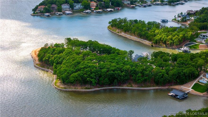 Discover an unparalleled opportunity to own a prestigious lakefront estate cove lot in the exclusive Villages at Shawnee Bend, the crown jewel of Lake of the Ozarks. An expansive 1.4 acres of impeccably flat terrain, this extraordinary lot in the coveted East Village Estates boasts breathtaking, panoramic lake views. Primed for your private cruiser dock, it promises a lifestyle of unparalleled leisure and cherished moments with family and friends. Gracing the shoreline is 362 feet of premium stacked limestone seawall, exquisite in both form and function. Included with this rare offering are bespoke architectural blueprints, masterfully designed specifically for this lot. Homes in The Villages at Shawnee Bend are elevated by unrivaled amenities, as well as community water, central sewer, and fiber-optic gig internet, all seamlessly integrated underground for an unobstructed aesthetic. This is not merely a lot—it is the epitome of sophistication and exclusivity, the finest parcel available in the Lake’s most prestigious luxury development, The Villages at Shawnee Bend. Secure your legacy in this elite lakeside haven today.