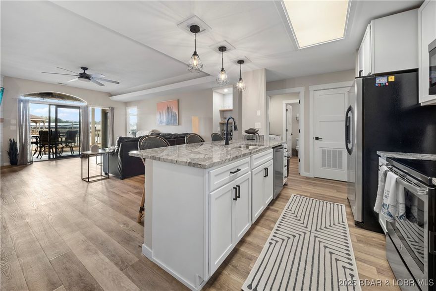 Gorgeously updated Lakefront Condo! This unit sits directly @ poolside overlooking the main pool & lake allowing you to be included in all of the festivities. Featuring Custom Cabinets w/ Granite counter-tops & center-island, SS Appliances, a mini-bar, pendant lighting, newer fixtures & LVP flooring throughout the main, Extra tall ceilings & so much more! The Master Bedroom suite is huge & the Master Bath has been updated w/ a double sink vanity, tile flooring throughout & tile surround w/ a walk-in shower. Hall bath updated as well & this unit is handicap accessible through the ramp going into the pool area. The dog park is next to this building, Trailer parking is allowed, accessible ramp is only a few minutes away & you may purchase a garage, pwc or boat slip as they become available. Walk across the street to find a ton of entertainment including Pool-Bars, Hot Tubs, Music, Dancing & Dining @ Camden / H. Toads, Lazy & Shady Gators. Cove @ this complex is fantastic as well, calm, great for paddle boarding & the famous Alhonna in the same cove & across the Main is Tap & Grill & in either direction for many additional options! TURN-KEY furnished