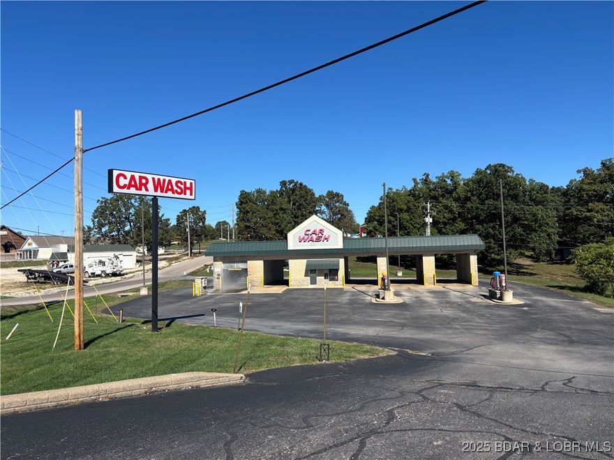 Discover an exceptional commercial opportunity in the heart of Laurie, Missouri—a high-visibility Car Wash featuring state-of-the-art equipment, modern conveniences, and a strong presence along one of the area’s most heavily traveled corridors. This prime location offers excellent visibility and consistent traffic flow. The property includes five total bays: four oversized manual wash bays and one fully automated bay. Each manual bay is equipped with high-pressure sprayers, multi-setting wands, foaming brushes, premium soap delivery systems, and handheld dryers, giving customers the ability to complete their wash with a professional-quality finish. The handheld dryers allow drivers to remove water from mirrors, grills, handles, and trim—an upgrade not commonly found in standard car wash. The automatic bay features advanced, user-friendly technology with touchless capability, and dependable performance that keeps vehicles moving efficiently even during peak hours. The spacious lot provides easy ingress & egress, and room for possible expansion or the addition of vacuum or vending stations, please see MLS 3582584 for 1.4-acre parcel includes one car garage/shop for add'l $.