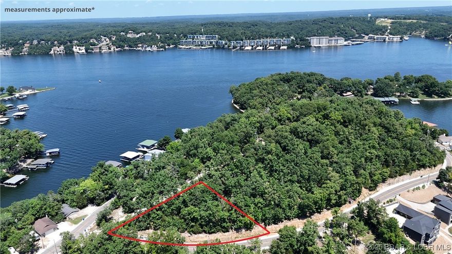 Nice little triangular shaped second tier lot with a seasonal lakeview.  Lightly restricted with blacktop roads on two sides.  Ideal for a shop or small home.  Access to City of Lake Ozark sewer nearby.  Hard to find on Horseshoe Bend with minimal restrictions.