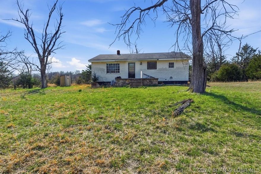 Fixer Upper Farmhouse, Garage, & 389 Acres spanning across three counties and offering a strong combination of productive pasture, mature timber, live water, and excellent recreational appeal! The property includes 5 large open fields along with an additional string of fields that work perfectly for shooting lanes, food plots, or to hay. Multiple creek crossings, 4 year-round ponds, and a natural spring provide consistent water throughout the tract. The terrain lays exceptionally well with flat ground and gentle topography in the pastures, creating numerous quality building sites and easy access across the property by ATV or UTV and a mix of terrain in the timber acreage. Strong deer and turkey presence make this an outstanding hunting tract with food plots maintained in recent years and bedding areas. Over a mile of road frontage between Waisner Ave and Purmiville Dr adds flexibility and access. Unlimited possibilities for homesteading, hunting paradise, running livestock, or developing!