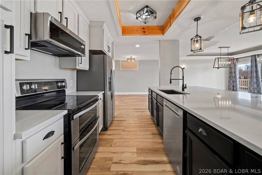 Experience modern lake living in this beautifully remodeled 4 bedroom, 5 bathroom home located in a prime Lake Ozark location just steps from Shady Gators and H. Toad’s. This stunning three-level home features an open concept design with stylish modern finishes and beautiful LVP flooring throughout. The spacious layout is perfect for entertaining and everyday living.

The expansive master suite offers a true retreat with a massive walk-in closet and a luxurious bathroom featuring a walk-in shower. The lower level adds additional living space with a comfortable family room and a convenient kitchenette/bar area, ideal for hosting guests.

Step outside to enjoy two decks with beautiful lake views—one covered for year-round enjoyment and one open for soaking up the sun. Additional features include a 2-car garage with extra parking, community dock access, and unbeatable proximity to some of the lake’s most popular waterfront spots.

Whether you’re looking for a full-time residence, vacation getaway, or investment opportunity, this home offers the perfect blend of modern comfort, entertainment space, and lake lifestyle.