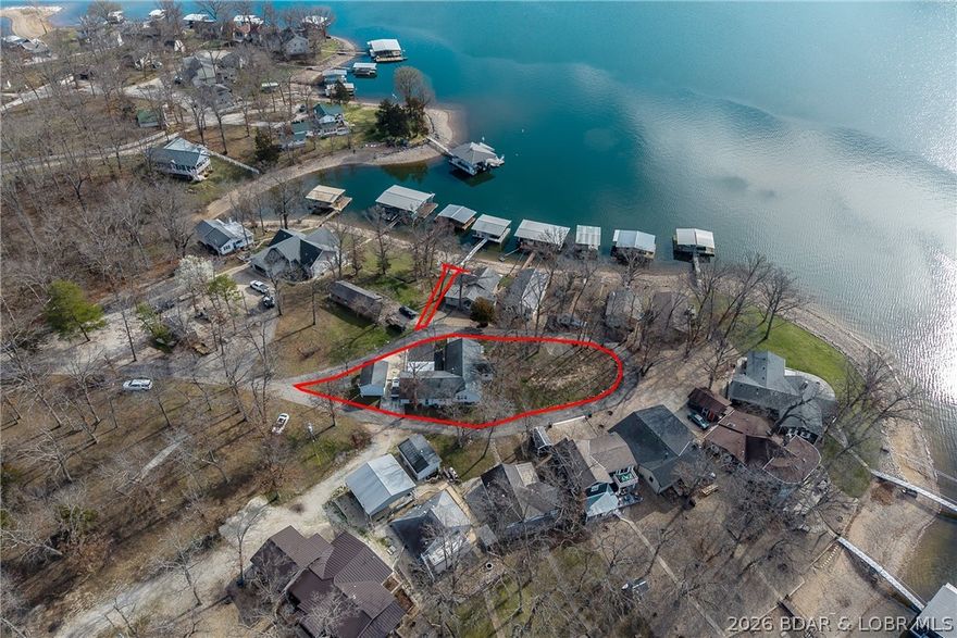 Seller has transformed this older home into a very comfortable full time home with lots of creative and thoughtful ideas. Sitting in the tear drop of the subdivision who have blacktop and lakeviews for 360 degree. The level lawn is great for outdoor activities. Your private covered dock is just steps for your front door and no stairs to the dock, The open floor plan features one level living, 2 living areas an office, finished sq. ft. in the attic and master suite with huge walk-in shower and huge walk in closet with lots of built-ins. Great location by road and water.