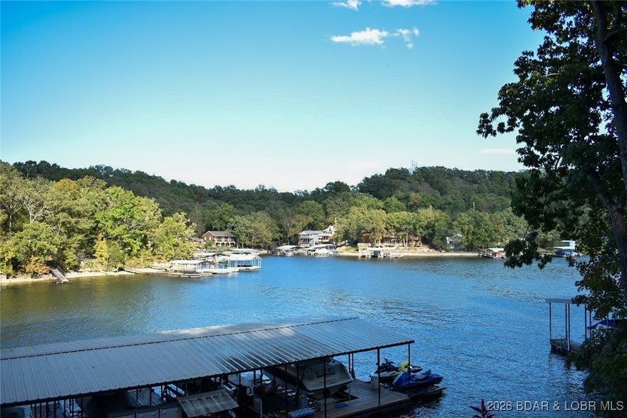 Welcome to your dream retreat!  With a 3,000 landscaping credit!! This stunning property features a brand new septic just installed in Jan. 2026. The kitchen was remodeled in 2024, the interior provides modern comfort and style.   Paved roads lead to the property which is in the same cove as the Cave Bar & Grill and close to the west side favorite hot spots by water and land.  Fishing enthusiasts are sure to catch a big one right off the dock. This property features a shared dock with its own 2 10x24 slips perfect for boating enthusiasts and water lovers alike.  With the added bonus with availability for nightly rentals, this home offers excellent income potential. Plus there are no HOA fees to worry about, making it an ideal investment property or personal retreat!