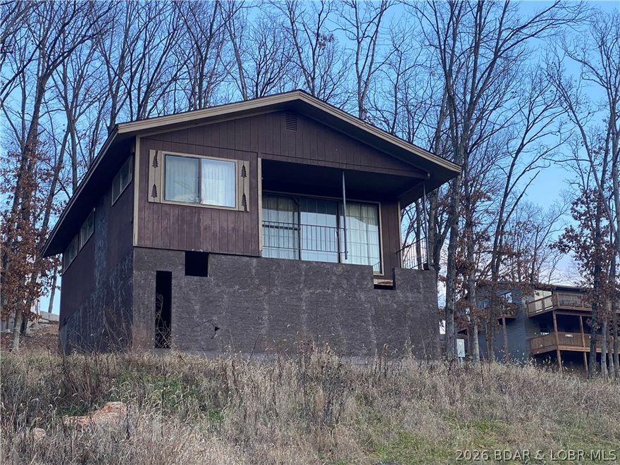 Unique opportunity for a Fixer Upper. Turn this home into your own Lake escape, full time residence, Air BnB, or just fix and flip.  Home is finished, and furnished, on the upper level, sitting on a new unfinished walk-out basement that can be finished to your specs. Currently a 3 bedroom 2 bath. Full kitchen, dining area, and living room. All utilities are run to the home and just need hooked up. Hook-up the utilities and you could live in the home while doing your renovations. Home is being sold as-is.