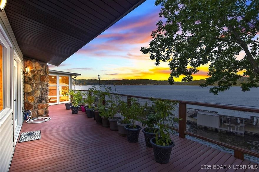 Welcome to your dream lakefront retreat in the Lake of the Ozarks— Nestled on the desirable 2nd mile marker in the Gravois Arm, this beautifully updated (2023) 4-bedroom, 3-bath home offers million-dollar views and over 100 feet of pristine lakefront. (Fourth bedroom is non conforming.) With 2,430 sq ft of thoughtfully designed living space, you’ll enjoy stone fireplaces on both levels, a large carport, and a two-car garage with abundant storage. Seamless indoor-outdoor living awaits with an outdoor kitchen, private concrete boat ramp. Wake up in the master suite to breathtaking views and step right out to a hot tub overlooking the water—perfect for morning coffee or evening stargazing. This is a rare opportunity to own a turnkey slice of paradise conveniently located a short boat ride away to Jolly Rodgers, Dock Knockers, and more .  Schedule your private showing today and start living the lake life you’ve been dreaming of!