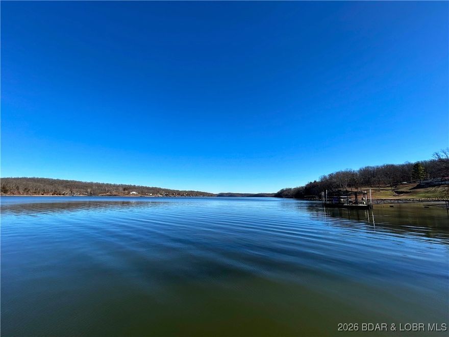 Waterfront opportunity on the Osage River at mile marker 75–76 with direct access to both Lake of the Ozarks and Truman Lake. This 3-bedroom, 1-bath home offers 768 finished square feet and sits on nearly 1 acre across three individual parcels, creating a rare large double-lot. The property features 163 feet of waterfront with breathtaking 180-degree views and includes a private 2-slip dock and boat Lift. Improvements include a newer roof, durable vinyl siding, and 200-amp electric service. Additional amenities include a detached 1-car garage, carport, and outbuilding. Built in 1988 and sold fully furnished. Located approximately 30 minutes from shops, restaurants and grocery stores in Warsaw. Now is your chance to turn your 2026 lake dream into reality!