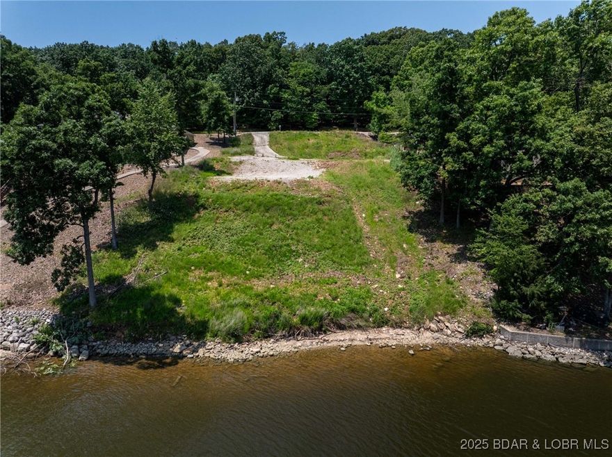 100' of lakefront x 210' deep in a great cove off of HH.  This is your chance to live in a great neighborhood but not have to be restricted by Four Seasons governance.  This buildable lot is located on Horseshoe Bend off Cherokee Road. Close to everything fun by land and water. Large cove, deep water and room for a huge dock. With 100 feet on both the street side and lakeside you have a great footprint for both a home and dock.  Property is large enough for a 5-6 bedroom house with a pool, large garage and plenty of parking. A majority of excavation has been completed and an existing drive which will be convenient for construction is in place. The old foundation you may find in old pics has been removed and lot is ready to go. No HOA fees.