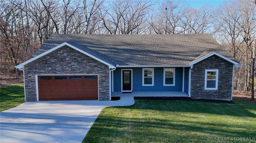 Brand-new beautiful home in the highly sought-after subdivision within Porto Cima! Located on a quiet cul-de-sac off the main drag of Grand Point & situated on wooded lot that backs up to POA property to ensure privacy & serenity. This thoughtful build has an open concept design for everyday convenient main floor living. The layout flows seamlessly from the bright great room with vaulted ceilings, to stylish kitchen featuring quartz countertops, stainless farm sink, crown moulding & LVP flooring throughout. Enjoy morning coffee on the covered porch or unwind in the evening on your trex deck. Master suite with large picture windows, huge walk-in shower w/ stunning floor to ceiling tile & even a electronic bidet! Spoil yourself in either bath with jetted shower control bars and quartz vanities. Extra details like LED halo lightning, large ceiling fans, & hyper HVAC system for affordable utilities. Plus a finished 2 garage that is heated/cooled for year round comfort! Get access to incredible community amenities—pickleball courts, tennis courts & pool—perfect for active lifestyle. Ideal comfortable living with a beautiful yard in a great neighborhood- come see today!