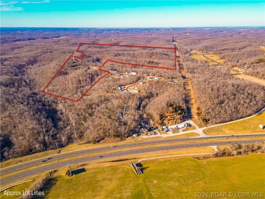 Incredible 140-acre development opportunity perfectly situated between Eldon and Lake Ozark, just minutes from the Bagnell Dam Strip. This gated property has a preliminary plat for 63 residential lots, with easements in place and access to community water, sewer, and electric—making it ideal for immediate or phased development. Located outside city limits, the land offers flexible use options, including single-family homes, multifamily housing, storage units, or luxury “man cave” barndominiums. With flat terrain, unmatched privacy, and infrastructure ready to go, this is a rare chance to create something special in one of Missouri’s most sought-after regions. The property sits right in between Eldon & Lake Ozark and is just minutes away from the Bagnell Dam and some of the best shopping, dining, and entertainment the lake has to offer.