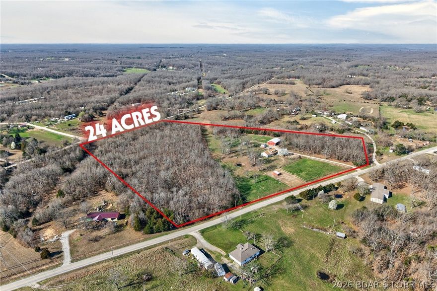 Great 24-acre hobby farm on Hwy WW in Lebanon with blacktop access to a gated entrance! This mini farm offers a great mix of open pasture and woods, making it ideal for livestock, horses, or hunting. The property is fully set up with multiple outbuildings, including a 30x60 barn with three 10x20 stalls, tack room, 10x20 lean-to for hay, tons of storage, full electric, and a bathroom (water line from house to barn needs replaced). Also included are a 55-ft corral with river sand footing, 14 fruit trees including apple, peach, pear, and crabapple, two duck coops, an 18-bird chicken coop, and a 3-ton feeder. Fenced and cross-fenced for cattle, goats, and horses.
The 3-bedroom, 2-bath home offers approximately 1,800 sq ft with a large kitchen, abundant cabinetry, center island, spacious mud/laundry room with sink, living room with coffered ceilings and gas fireplace, plus a dining/den area. A covered wraparound porch, back deck, and classic dormers complete the package. If you’ve been looking for manageable acreage with easy highway access and everything in place, this one is ready to go.