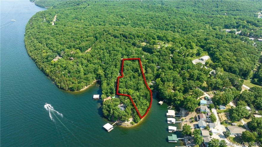 Pass through the gated entrance of Triple K Ranch & experience the timeless charm of this quiet, old-style lakeside community. With only a handful of homes inside this private enclave, this exceptional property offers over 2 acres & more than 300 feet of lakefront, perfectly positioned in a protected cove. Enjoy stunning main channel views at the 31MM, overlooking the iconic Four Corners of the Lake of the Ozarks. The combination of expansive space & breathtaking scenery creates an ideal setting for your vision. Whether you’re looking to build a private estate or develop two lakefront homes, the possibilities here are wide open. Usable lakefront in a cove setting is becoming increasingly hard to find, making this a rare opportunity to create your dream retreat on the quieter side of the lake. The property spans three combined parcels, offering generous room for additional structures such as a shop or multiple residences. For those seeking even more potential, additional surrounding properties & homes may also be available for purchase. Whether you're planning your next development or designing a custom lakefront escape, this unique offering is ready to bring your vision to life.