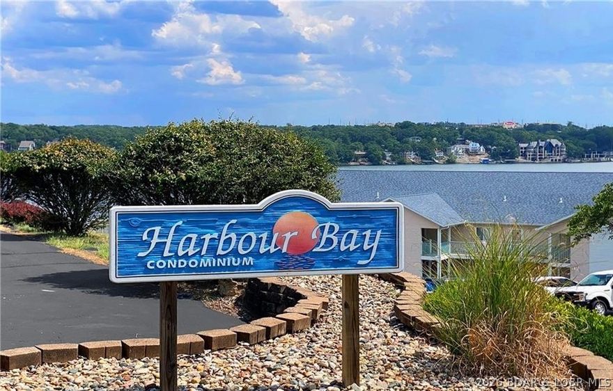 EXTRAORDINARY panoramic view of the main channel, and UNSURPASSABLE LOCATION! Harbour Bay is nestled between the luxury communities of Porto Cima and The Villages, in the heart of the lake at the 18MM. This condo puts you near Backwater Jacks, the Grand Glaize Arm, and Margaritaville, with countless restaurants & amenities nearby by both land and water!
This adorable, nautical-themed, waterfront condo has 1185 spacious sq. ft. with 3-bedrooms and 2-bathrooms. It is furnished, turnkey, and includes a coveted 14'X40' Boat Slip with REMOTE HOIST for enjoying Lake Life to the fullest.
Harbour Bay is smaller, well-maintained complex with BIG benefits. Secure GATED community. Fresh siding and repairs. The dock is protected by a WAVE-BREAK. To give even more peace of mind, the condo & the slip monitored with Lonex Security WIFI multiple camera system. 
Enjoy the sounds of summer and spend hours watching boats and relaxing on the deck.  Schedule your showing TODAY!