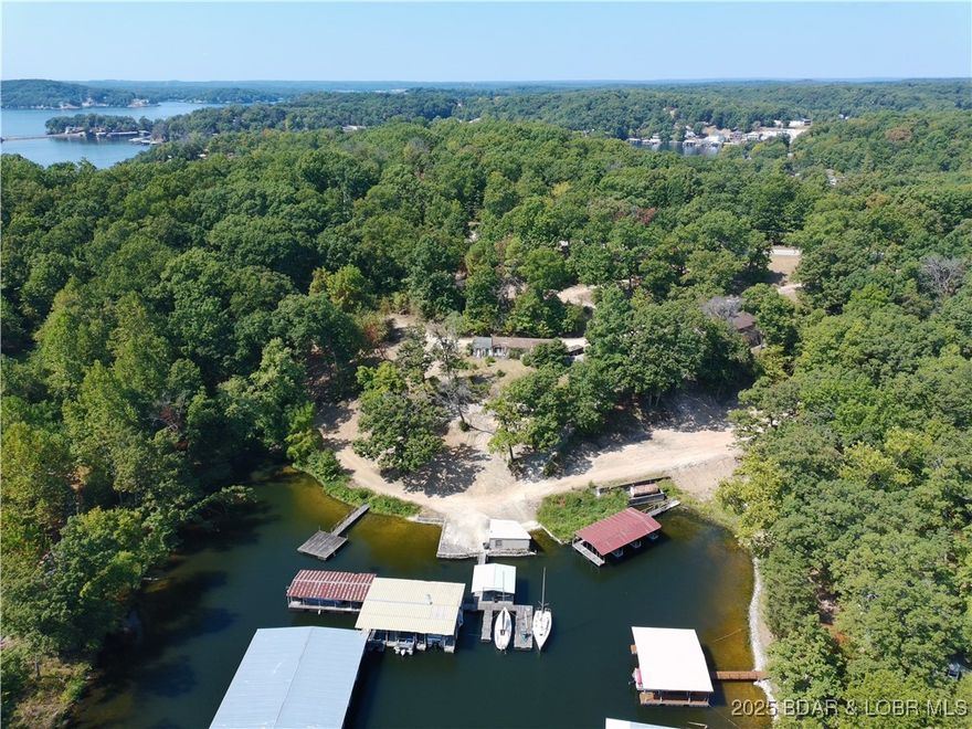 Welcome to Shady Oaks Resort! This is a beautiful piece of property located 15 minutes from Lake Ozark. This property offers plenty of build sights and with over 330 feet of waterfrontage the possibilities are endless. This property offers a huge dock envelope as well that provides access for over 19 different boats, a swim platform, and even has the ability to be converted into a gas dock. What was once an incredible resort in a pristine location can now be yours  on the 3MM of the beautiful Lake of the Ozarks.