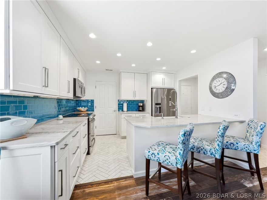 Beautifully updated 2-bed, 2-bath furnished condo at Oak Bluff on Lake of the Ozarks, featuring breathtaking views of the Big Niangua and a 10x26 boat slip. The standout feature is the completely remodeled kitchen w/ custom soft-close cabinetry, quartzite countertops, stainless Maytag appliances with Samsung range, herringbone tile flooring, and exceptional counter and storage space rarely found in a condo of this size. Additional pantry space with washer and dryer. The open living area features attractive LVP flooring, updated lighting, and a stylish wet bar with custom cabinetry and built-in ice maker. The living room and primary suite both walk out to a generously sized screened concrete deck overlooking the lake, complete with a storage closet. Easy access with parking directly in front of the unit and only 6 steps to the front door. Oak Bluff amenities include an outdoor pool, clubhouse with whirlpool, exercise room, sauna, and billiard room. Excellent boating location on the Big Niangua, with quick access to The Cave, NautiFish, Bridal Cave, and Ha Ha Tonka State Park, and just minutes by land to Camdenton and the Ozarks Amphitheater for shopping, dining, and summer concerts.