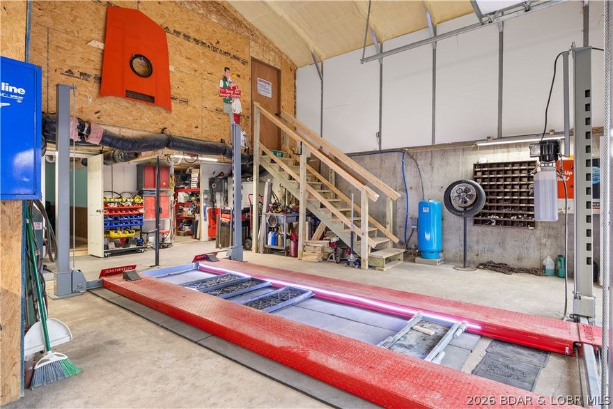 Welcome to the perfect blend of modern living and industrial utility. Built in 2022, this pristine 2-bed, 1.5-bathroom "Shouse" (Shop-House) is situated on nearly an acre of land, offering a rare sanctuary where privacy meets ultimate convenience. Located just moments from premier shopping, dining, & entertainment, this property provides a secluded feel without sacrificing accessibility. The residence is designed for durability & low maintenance, featuring high-quality metal siding, metal roof, & an inviting open deck surrounded by mature trees. Inside, the space is fresh and modern, but the true highlight lies in the expansive shop and garage facilities. A car enthusiast or mechanic’s dream, the property includes a 2-car attached garage equipped with a 9,000 lb Advantage Mobile Lift, a 1-car detached garage, a carport, and an RV pad with full hookups. NO HOA restrictions &nearly an acre to roam, the home offers incredible expansion capabilities for those looking to grow. Whether you need a professional-grade workspace, secure storage for your lake toys, or a stylish, minimalist residence, this property delivers. Move-in ready & available now—come experience this unique lifestyle!