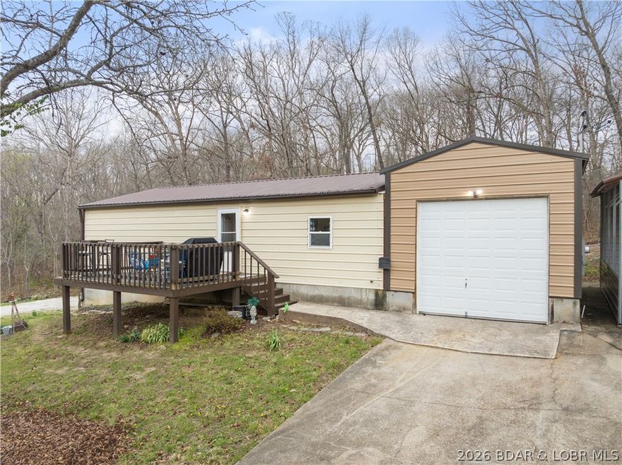 Welcome to the perfect blend of modern living and industrial utility. Built in 2022, this pristine 2-bed, 1.5-bathroom "Shouse" (Shop-House) is situated on nearly an acre of land, offering a rare sanctuary where privacy meets ultimate convenience. Located just moments from premier shopping, dining, & entertainment, this property provides a secluded feel without sacrificing accessibility. The residence is designed for durability & low maintenance, featuring high-quality metal siding, metal roof, & an inviting open deck surrounded by mature trees. Inside, the space is fresh and modern, but the true highlight lies in the expansive shop and garage facilities. A car enthusiast or mechanic’s dream, the property includes a 2-car attached garage, a 1-car detached garage, a carport, and an RV pad with full hookups. NO HOA restrictions &nearly an acre to roam, the home offers incredible expansion capabilities for those looking to grow. Whether you need a professional-grade workspace, secure storage for your lake toys, or a stylish, minimalist residence, this property delivers. Move-in ready & available now—come experience this unique lifestyle!