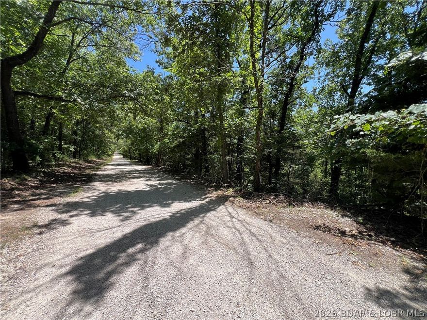 Ready to invest or develop? This 7.67-acre tract on the edge of Osage Beach offers a rare opportunity for small acreage so close to town. With over 950 feet of road frontage, the land is a mix of gentle, moderate, and steep wooded terrain—perfect for creative development or a private retreat. Located just minutes from Hwy 54 and a short drive to shopping, dining, and all that Osage Beach has to offer. Potential for 20+ home sites or design your own layout. Surrounding area features charming homes and a quiet setting, while still being close to conveniences. No utilities currently in place—bring your vision and plans! Currently zoned I-1.  Zone down for residential or leave it as it is and use it for light industrial.