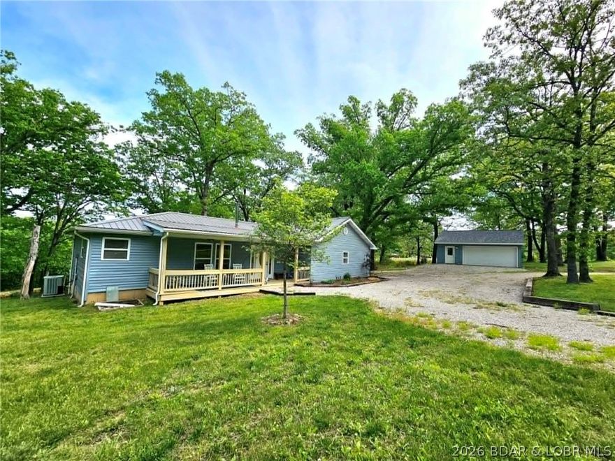 Enjoy instant equity with this country home, priced below appraised value and nestled on a peaceful 3-acre lot. This well-maintained property offers true one-level living with 3 bedrooms, 2 full baths, and an open-concept kitchen, dining, and living area—perfect for everyday living and entertaining. The kitchen features slate flooring and includes all appliances, with a refrigerator less than 6 mo old. Major updates add value and peace of mind, including a brand-new washer, a 2.5-yr-old dryer, hot water heater (1.5 years), and water softener (1 year). The spacious living room boasts vaulted ceilings with beautiful wood beams and flows seamlessly from the kitchen. The oversized primary suite includes a private en-suite bath. Take in the serene surroundings from inside the home or relax on the large deck overlooking a stocked pond and wooded acreage—perfect for enjoying abundant wildlife and nature. Situated just off a blacktop road, this secluded property offers both privacy and convenience. Additional features include a detached 2-car garage (only 2 yrs old) with electricity, a 3-stall pole barn located across the road, and a whole-home Generac propane generator for added security.