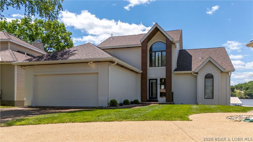 Lakefront living on a FLAT lot w/ HUGE view in the heart of Osage Beach with a NEW roof! This remodeled home showcases panoramic views of the Osage 25 MM & features a large breakwater for easy docking & a 2-well concrete dock with 2 PWC spaces. Upon entering, you'll notice the vaulted living room that centers around a beautiful gas FP & flows seamlessly into the open-concept kitchen & dining area. Main level deck & lower lvl covered deck are crucial for entertaining. A spacious loft with two full/twin bunks functions as a 4th bedroom. Recent upgrades include a brand-new primary bath (Oct 2025), rebuilt main & lower decks with composite decking, new soffit, wrapped front posts, fresh exterior paint, new interior sliders, Bosch HVAC & a newer completely redesigned kitchen with new custom cabinets, countertops, appliances and backsplash. Additional improvements include new flooring, lighting, plumbing fixtures & updated fireplaces. An abundance of natural light highlights the incredible lake views from main level & lower level. Ideal home for a full-time residence, second home OR nightly rental investment—just minutes from the lake’s favorite restaurants.