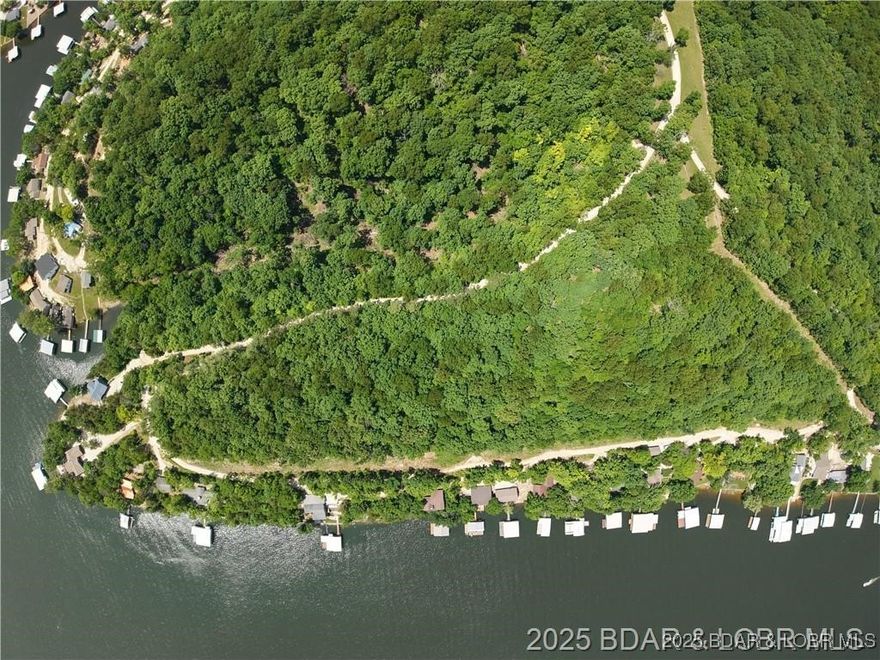 Incredible 9.16-acre property located on the 6MM of the Gravois Arm at Lake of the Ozarks in Barnett, MO, offering a rare combination of expansive second-tier acreage and development potential. With flexible purchase options, this property can be sold as a whole or divided in multiple ways to suit your vision. Whether you’re looking to build a private estate, a family compound, or a residential development, this property offers endless potential in a peaceful, desirable location.