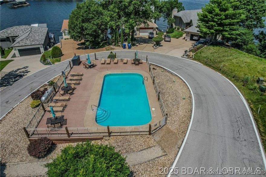 RARE OPPORTUNITY – The last remaining lot in the desirable Catalina Subdivision is now available! This second-tier property offers incredible lake views and is fully prepped with 400 amp electric service, well water, city water disconnect in place, sewer, high-speed internet, and a completed survey—all the hard work is done and it's ready for your custom home. Ideally located just 1 minute from both Kelly’s Port and Port 20, where boat slips are available in protected no-wake coves. Enjoy the perfect blend of luxury and convenience with Lake Regional Hospital, shopping, and top-rated dining just minutes away. Catalina features upscale homes, community pool access, and prime access by both land and water. A standout setting in one of Lake of the Ozarks’ most exclusive neighborhoods.