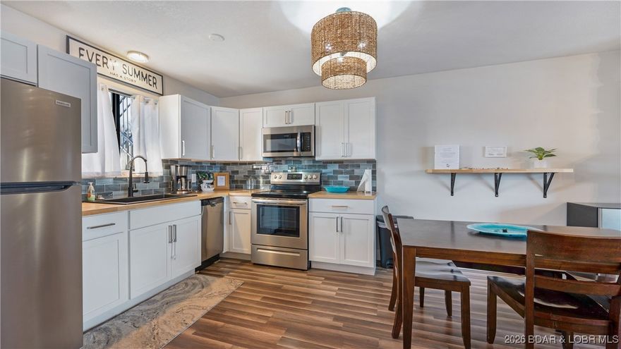 UPDATED TURNKEY CONDO in OUTSTANDING OSAGE BEACH LOCATION - This fully updated, turnkey condo is located in a protected cove, yet offers a massive main channel view from the expansive deck.  The kitchen has been fully renovated with all new cabinets, butcher block counter tops, gorgeous tile backsplash, appliances, sink, and fixtures, and an open layout allows for a lake view from the kitchen, dining area, living room and primary bedroom.  The unit is crisp and clean with new paint, trim, doors and LVP flooring throughout, and a fully renovated bathroom includes new vanity, sinktop, fixtures, tile flooring and tiled tub surround. The elevated pool with clubhouse provides a nice lake view and the complex is located right next to Shorty Pants, so you are able to just stroll next door to grab a bite to eat or get your party started. This location is so convenient to everything you want and need and allows for quick access by land or water to an abundance of shopping and favorite off-water and lakefront restaurants.  Now is the time to secure your Lake Getaway before the season begins, or get started with a rental investment property.