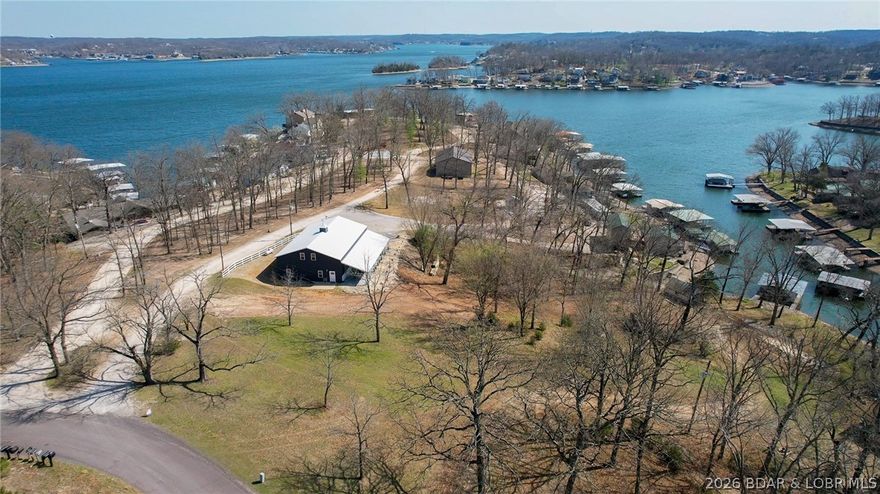 Bring your plans--here's the opportunity! With plenty of room to live, play & invest, this exceptional lakefront property offers quality construction, custom craftsmanship & future potential. Situated on 2+ acres with 200' of shoreline in a quiet cove, this newer home is designed for both enjoyment & entertaining. Open living, kitchen & dining area with vaulted ceilings, loft & stunning floor-to-ceiling pellet stove feature. Custom kitchen has a great pantry closet & coffee bar combo. Classic touches throughout the home. Main level primary suite has walk-in closet, laundry, bath & patio. Custom open stairway leads to family room, 2 bedrooms, full bath & bonus room ideal for office or 4th BR. Attached 800 sf shop/garage adds valuable storage & workspace. Private boat ramp, dock with lift & more dock permit possibilities. The acreage & lakefront layout offer outstanding development potential with room for possibly three additional lake homes, including space for another large waterfront home. A rare chance to own a well-built lakefront property with fantastic expansion potential. Live in one & develop a set of vrbo homes. Seller's have recently cleared some trees for larger view.