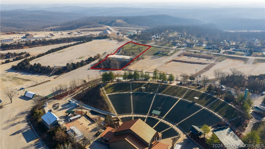 Positioned along North Business Highway 5 with 227’ of high-visibility frontage next to the Ozarks Amphitheater, this 10,950 SF commercial property presents a rare investment opportunity with multiple income and development angles. Built by Varco Pruden, the structure includes 7,700 SF of clear-span shop space with 18’ sidewalls and a 22’ peak—ideal for boat storage, contractor use, luxury toy storage, or future conversion concepts. The property also features 2,500 SF of finished living quarters with 2 bedrooms, 1 full bath, and 2 half baths, plus a 750 SF lower-level garage—offering potential for on-site management, rental income, or live/work flexibility. Additional land provides room for expansion or future building, enhancing long-term upside. Seller is offering owner financing options, adding flexibility for investors. With strong traffic exposure and versatile layout, this asset is well-suited for storage, showroom, or mixed-use potential in a growing Lake of the Ozarks corridor.