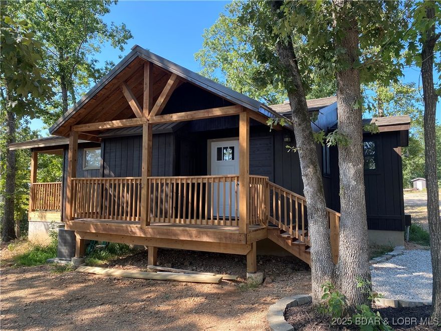 Quaint 3 bedroom 2 bath Cabin in a great location. Directly off State Hwy TT for easy access, on a level lot. Great for a second home or Investment for an Air BnB. Cabin has been partially remodeled with new entry deck, exterior paint, some windows, hvac, wiring and plumbing. Interior is a rustic wilderness theme, ideal for lake living. All furnishings and decor are included. Located conveniently off Highway TT, close to the Shawnee Bend public Access Ramp. Boat slip lease is thru the new Marina "Denali Summit" 1/4 mile down the road, close enough to take a golf cart to your boat.  Monthly rental history available.