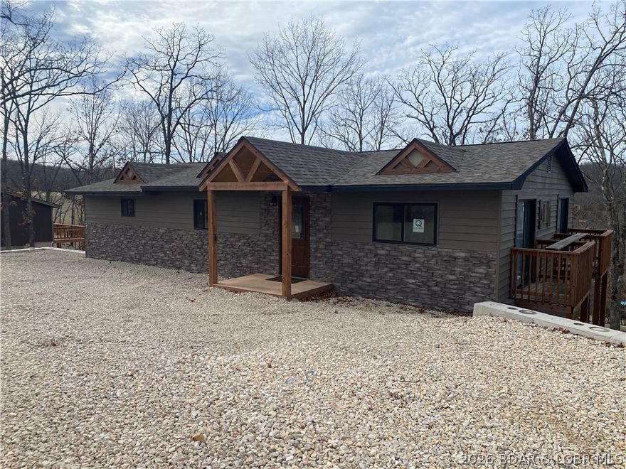 Putting the finishing touches on this remodeled 4-5 Bedroom home in a newly developed subdivision. Great curb appeal with partial stone veneer and dormer accents. The interior is expansive with large bedrooms, ample closet space and a bonus room and bathroom downstairs that have multiple possibilities, from additional bedroom(s), game room, man cave, or could be rented separately with the lock off door, side entry staircase and entry door. Two large 10x50 decks allow plenty of room for outdoor entertaining, or just enjoying the outdoors. Home offers a partial lake view, mainly in the off season. Nightly or long term rentals are allowed if you wanted to make this a real estate investment or just off set your expenses. Central water and sewer system, therefore an HOA. There are restrictions in place to maintain the aesthetics of the neighborhood, but nothing over bearing. Shawnee Bend public lake access is only 1/4 mile down the road. Boat slip rentals will be available a little further down the road at the new Denali RV park and Marina. Both just a golf cart drive away. More photos to come...