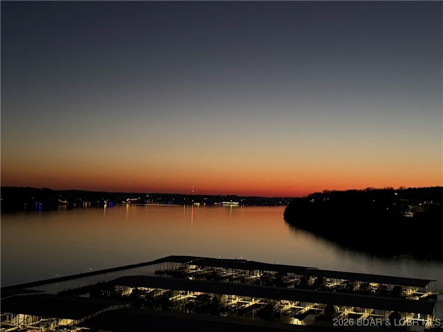 Top-Floor Lakefront Penthouse with Panoramic 5 Mile View + Boat Slip Included! Wake up to sweeping main channel views & unwind each evening with unforgettable unsets from this lakefront penthouse at Palisades Condominiums. Perfectly positioned for both privacy & perspective, this 3 bed, 3 bath retreat features vaulted ceilings & an open-concept layout designed to bring the outdoors in. The spacious living area flows seamlessly onto a private deck overlooking the water-ideal for morning coffee, entertaining or simply enjoying the lake lifestyle. The kitchen offers granite countertops & a functional layout that opens to the main living space making it easy to host family & friends after a day on the water. Offered fully furnished this property is move-in ready whether you're looking for a weekend getaway, second home or invest opportunity. 12X32 boat slip is included so you can spend less time planning & more time on the water. Located in the desirable Palisades community, you'll enjoy a peaceful setting just minutes from popular lakefront dining, shopping & entertainment. If you've been searching for a low-maintenance lake retreat with big views & even bigger potential, this is it!