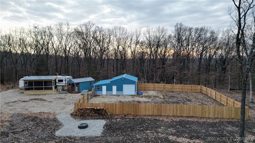 Your private 5 acres are waiting!Fully set up, beautifully maintained, and ready for you to make it home. Whether you’re looking for a weekend getaway, a full-time residence, or the perfect place to build down the road, this property gives you the space, comfort, and flexibility you’ve been searching for. The land includes a well-kept 38’ front-living, 5-slide Forest River Creek fifth wheel that has been thoughtfully cared for. Inside, you’ll find a roomy bedroom, a cozy living room, a functional kitchen, and a standard laundry hookup—plus a screened-in porch. A standout bonus is the 25x32 building on the property, complete with epoxy flooring, full insulation, and mini-splits on both sides to keep the space comfortable year-round with laundry hook ups. With water and electricity already in place, this building is perfect for storage, or converting into additional living space. A brand-new well and lagoon have already been installed, giving you reliable utilities and peace of mind. Keep the setup just as it is for a low-maintenance retreat, build your dream home, or customize the property to fit your vision—the possibilities are truly endless on this beautiful 5-acre piece.