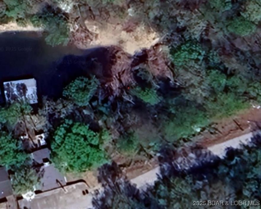 Lakefront Living at an Unbeatable Price! Discover the rare opportunity to own a lakefront lot in the highly desirable Yacht Club Estates Subdivision—a peaceful and tranquil setting perfect for your custom lakefront home. This cove-protected lot offers calm waters and Lake views, ideal for boating, relaxing, and enjoying the beauty of lake life. Located within the School of the Osage District, this property is perfect for families or anyone seeking a serene escape with access to top-rated schools and community amenities. Imagine waking up every day to the sights and sounds of the lake, all while enjoying the privacy and calm only a cove location can provide. Where else can you find a lakefront lot at this price? Don’t miss your chance to build your dream home in one of the lake's most peaceful and well-established communities.