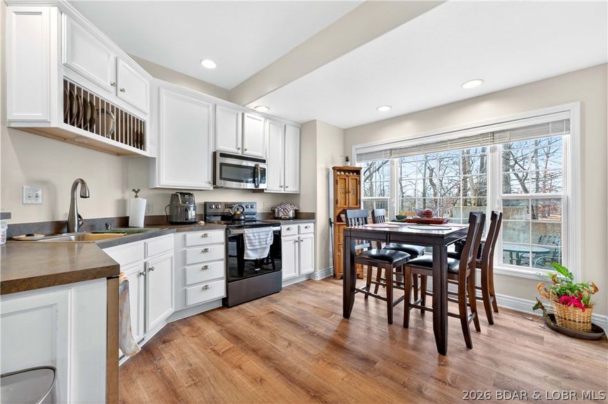 10 Anemone Rd in Lake Ozark offers the ease of main-level living in Four Seasons with 3 bedrooms, 2.5 baths, and 1,736 sq ft on a generously sized 0.53-acre corner lot. This 1.5-story home features vaulted ceilings, custom cabinets, a pantry, laminate flooring, a gas fireplace, walk-in closet, walk-in shower, attached oversized 1-car garage, open deck, patio, and fenced outdoor space for everyday comfort and entertaining. Located in the sought-after Four Seasons community, owners enjoy access to outstanding amenities including pools, clubhouse, tennis courts, workout facilities, playgrounds, dog park, campground, and more, adding to the Lake of the Ozarks lifestyle appeal.