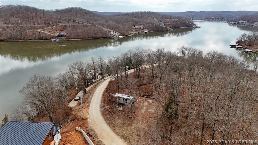An  AMAZING getaway set up and ready to enjoy!  An almost 2-acre lot with a seasonal view of Lake of the Ozarks at the 55MM. PLUS a waterfront lot just a short distance away to put your own dock!!  Includes a 2016 Heartland Sundance 3270RES RV with all the utilities in place (water, septic, electricity) including COMO fiber. 3 slide-outs. Queen bed. Boat ramp, rental docks and bait store nearby! Options to keep the RV for weekends or remove and build a lake home with a view!   Don't miss out!