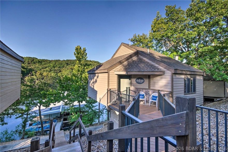 Enjoy lakefront living in this inviting villa located in a quiet cove with calm water, perfect for relaxing and soaking in the views. The open-concept design features vaulted ceilings and large windows that fill the space with natural light while connecting the kitchen, dining, and living areas. The kitchen offers ample cabinet space and a functional layout that flows easily into the main living space, ideal for everyday living or entertaining. The large windows provide great lake views. With multiple living areas and well-separated bedrooms, the layout provides both comfort and flexibility for family and guests. As a free-standing villa, you’ll appreciate the added privacy with no neighbors above or below. Outdoor spaces are designed for enjoying the peaceful lake setting. Located in the coveted Holiday Shores community, this villa grants you access to resort-style amenities that make every day feel like a vacation. Relax and soak up the sun on the large swim dock, take a refreshing dip in the gradual-grade pool, or let the kids enjoy the splash zone and playground. Ideal as a full-time home, vacation retreat, or investment opportunity.