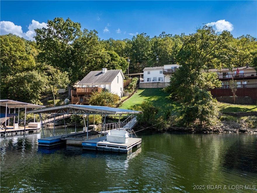 Located in one of the lake’s most desirable neighborhoods off Horseshoe Bend Parkway, this lakefront home checks all the boxes—big views, year-round deep water, and the flexibility to enjoy it as a personal home or vacation rental. This is one of the few homes on the street with a garage and a gentle driveway, offering a rare convenience. Outside entertainment is where this home truly shines. You'll find an enclosed storage room that’s full of potential - imagine creating your dream man cave, outdoor kitchen, game room, or whatever fits your lake lifestyle. The deep water ensures your dock and lake toys are ready to use year-round, and the views are the kind you’ll never get tired of. Whether you’re looking to make it your full-time home, weekend getaway, or income-producing rental, this property is ready for your personal touch. Come see why this Horseshoe Bend gem is such a rare find!